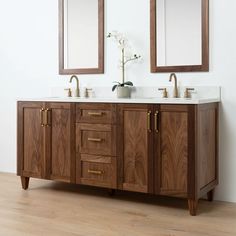 two mirrors are above the double sink vanity