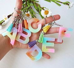 a person holding some type of keychain with the word eff on it