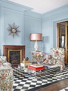 a living room with blue walls and black and white checkered flooring on the floor