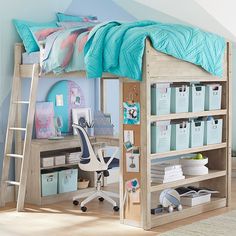 a loft bed with a desk underneath it in a room that has blue walls and wooden floors