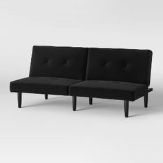 two black couches sitting next to each other on a white surface with no one in it