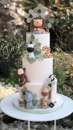 a three tiered cake with animals on it