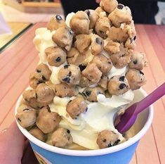 a blue cup filled with ice cream and chocolate chip cookies