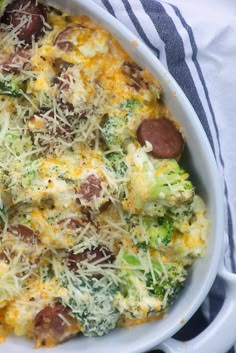 a casserole dish with broccoli, sausage and cheese