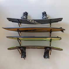 three surfboards stacked on top of each other with one person's feet in the air