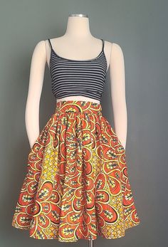 This summer African print cotton gathered knee length skirt with side pockets and zipper in the back is a must have.  Details: high waist, in seam side pockets, full gathered skirt Garment Measurements: on Mannequin Waist: 28 in - Can made to order Hips: FREE Full Length: 24 in READY TO SHIP IN 3 DAYS Machine Washable (cold with like colors suggested)  and Dryer Safe  Hand wash is better to preserve the brilliance of the colors -CUSTOM REQUEST AVAILABLE- Please measure your waist and use the siz Cotton Midi Skirt With Side Pockets, Multicolor Summer Skirt With Pockets, Summer Multicolor Skirt With Pockets, Multicolor Cotton Knee-length Skirt, Multicolor Knee-length Cotton Skirt, Orange Summer Skirt With Pockets, Orange Mini Skirt With Pockets, White Hall, Orange Graphic