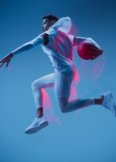 a man is jumping in the air with a basketball