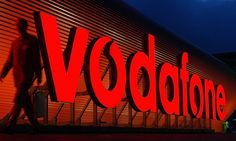 the vodbone sign is lit up at night