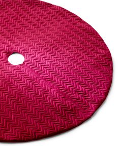 a red round cutting board with a hole in the middle