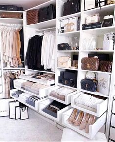 an organized closet with white shelving and lots of shoes, handbags and purses