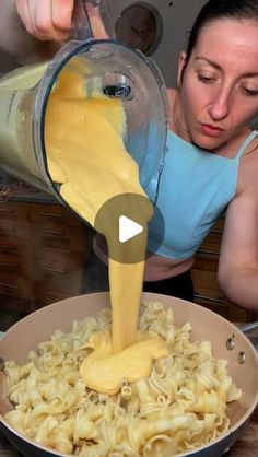 a woman pouring sauce over pasta in a pan