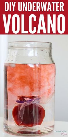 a glass jar filled with water and some fruit in it that says diy underwater volcano