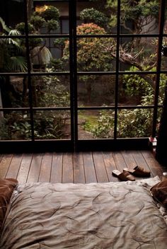 a pair of shoes sitting on top of a wooden floor in front of a window