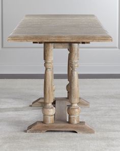 an old wooden table with two columns on the top and one column at the base