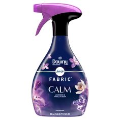 a bottle of fabric calm on a white background with purple flowers in the sprayer