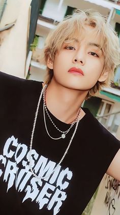 a young man wearing a black shirt with the words cosmic crusher written on it