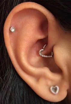 a close up of a person's ear with two piercings