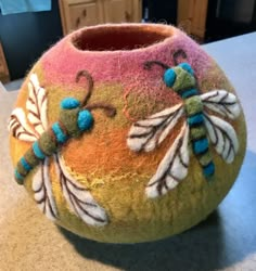 a colorful vase sitting on top of a counter