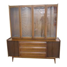 a large wooden cabinet with glass doors on it's front and side panels open