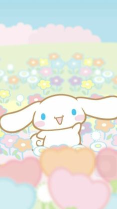 a cute little bunny sitting in the middle of some flowers and hearts on a blanket