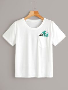 a white t - shirt with a cactus pocket on the front, and a green embroidered pocket on the back