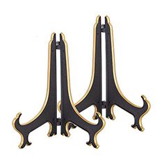 two black and gold bookends sitting next to each other on a white background