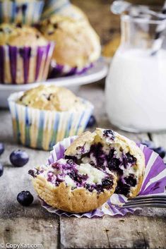 two blueberry muffins with one cut in half