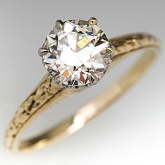 an old - fashioned diamond ring with filigrees is shown in yellow gold