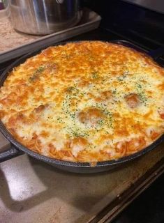 a cheesy pizza sitting on top of an oven