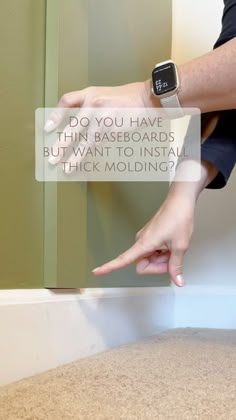 a person reaching for an apple watch on their wrist with the caption do you have thin baseboards but want to install thick molding?