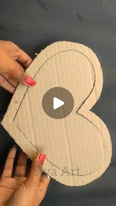 someone is making a heart out of cardboard