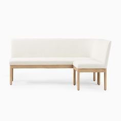 a white couch sitting on top of a wooden frame