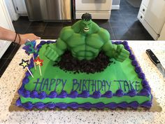 a hulk cake with the words happy birthday take on it's green and purple frosting