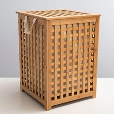 a wooden basket sitting on top of a white table