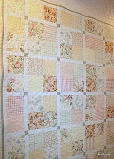 a large quilt hanging on the wall