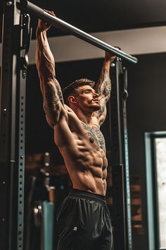 a man doing pull ups in the gym