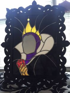 a stained glass window in the shape of a woman's face with a crown on her head