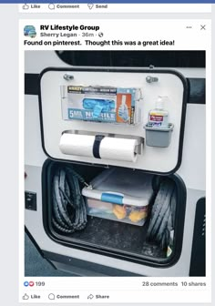 the back of a bus with its door open and some items in it's trunk