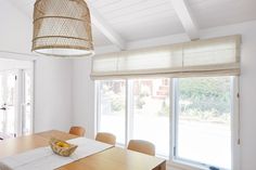 a dining room table with chairs and a basket on it