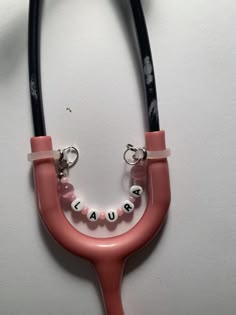 a pink stethoscope with the word cause on it