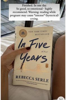 a person holding up a book in front of their face with the title in five years written on it