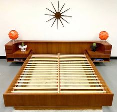 a wooden bed with two nightstands and a clock on the wall