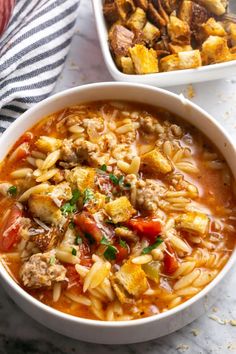 two bowls filled with pasta and meat soup