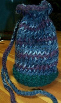 a knitted hat sitting on top of a wooden table