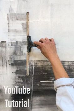 a person painting a wall with the words youtubee tutorial written in front of it