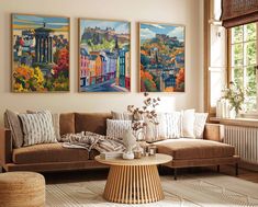 a living room with three paintings on the wall