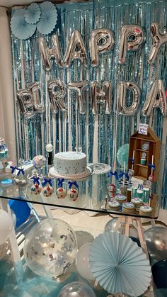 a birthday party with balloons, cake and decorations