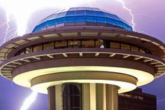 lightning strikes behind the space needle at night