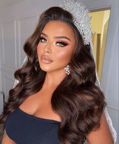 a woman with long hair wearing a bridal tiara and diamond headpieces