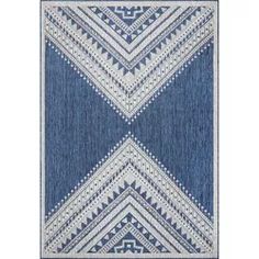 a blue and white rug with an intricate design on the bottom, in front of a white background